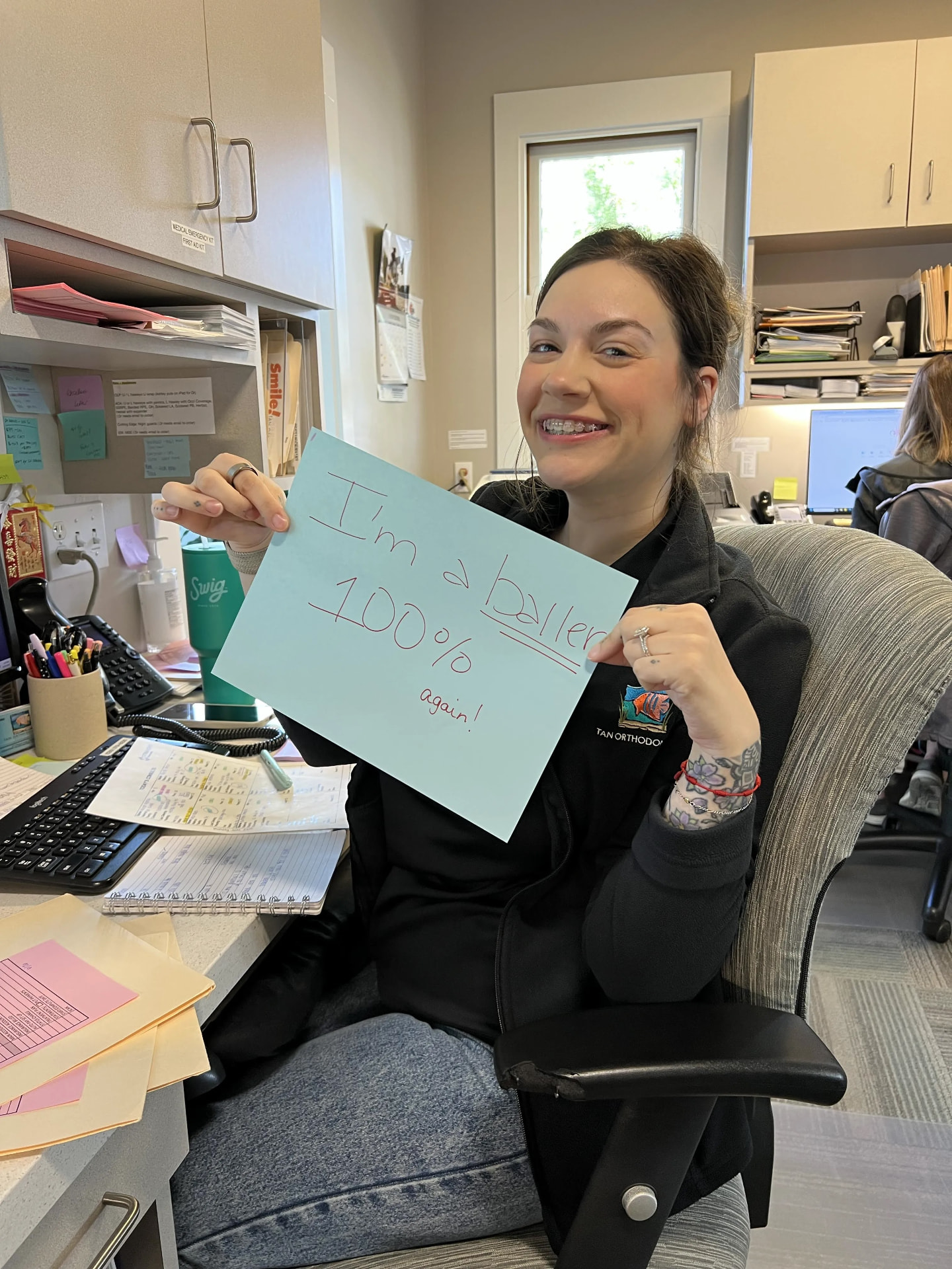 Tan Orthodontics front-desk team member celebrating 100% conversion