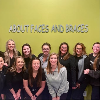 A dental office team, all smiling as a group